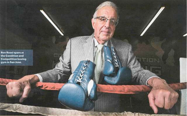 Photo of attorney Ronald r. rossi with boxing gloves around neck
